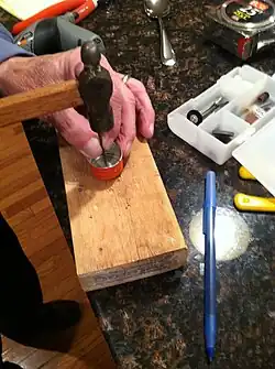 Step 6: Created a "dimple" in the metal bottle cap used with the middle bottle (with a dull nail).